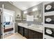Bathroom with double sinks, large mirror, and decorative wall tiling at 1823 Ashton E Dr, St Cloud, FL 34771