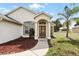 Inviting front entryway with a decorative door and a well-maintained landscape at 1823 Ashton E Dr, St Cloud, FL 34771