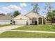 Charming single-story home with well-maintained landscaping, a two car garage, and manicured lawn at 1823 Ashton E Dr, St Cloud, FL 34771