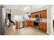 Well lit kitchen with tile floors and modern appliances and wooden cabinets at 1823 Ashton E Dr, St Cloud, FL 34771