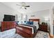 Comfortable main bedroom with ceiling fan, large dresser, night stands, and calming decor at 1823 Ashton E Dr, St Cloud, FL 34771