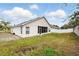 Wide view of backyard and rear exterior of a single story home featuring a screened in lanai at 1823 Ashton E Dr, St Cloud, FL 34771