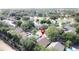 An aerial view showcases the property's proximity to lush trees and neighborhood amenities at 2365 Paulette Dr, Haines City, FL 33844