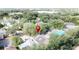 Aerial view of a neighborhood with lush greenery, rooftops, and a sparkling community pool at 2365 Paulette Dr, Haines City, FL 33844