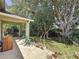 View of a shaded backyard with mature trees and a covered patio, perfect for outdoor living at 2365 Paulette Dr, Haines City, FL 33844