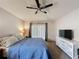 Inviting bedroom with a ceiling fan, plush carpet, and a view of the backyard through sheer curtains at 2365 Paulette Dr, Haines City, FL 33844