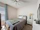 Comfortable bedroom featuring a large window for natural light and a modern lamp and nightstand at 2365 Paulette Dr, Haines City, FL 33844