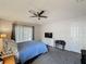 Comfortable bedroom with a ceiling fan, carpet flooring, and natural light from the window at 2365 Paulette Dr, Haines City, FL 33844