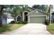 Charming home featuring arched entryway, well-manicured lawn, and two-car garage at 2365 Paulette Dr, Haines City, FL 33844