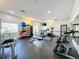 Fitness center with a variety of exercise equipment, weights, and ample natural light at 2365 Paulette Dr, Haines City, FL 33844