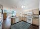 Open kitchen featuring a granite countertop island, stainless steel appliances and a blue patterned rug at 2365 Paulette Dr, Haines City, FL 33844