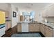 Kitchen island featuring a stainless steel sink, granite countertops, and view of the living room at 2365 Paulette Dr, Haines City, FL 33844