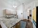 Bright kitchen featuring granite countertops, stainless steel sink, and modern appliances at 2365 Paulette Dr, Haines City, FL 33844