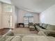 Spacious living room showcasing neutral tones, arch window, and wood-look floors at 2365 Paulette Dr, Haines City, FL 33844