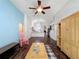 Spacious living room featuring hardwood floors, a ceiling fan, and open access to the kitchen at 2365 Paulette Dr, Haines City, FL 33844