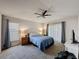 Relaxing main bedroom featuring neutral tones, a ceiling fan, and large windows for plenty of natural light at 2365 Paulette Dr, Haines City, FL 33844