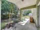 Cozy covered patio featuring seating, potted plants, and views of the private backyard at 2365 Paulette Dr, Haines City, FL 33844