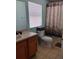 Bright bathroom featuring a toilet, tiled flooring, a shower/tub, vanity, and a window at 247 Verona Ave, Davenport, FL 33897