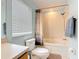 This bathroom features a tub and shower combination, as well as a toilet and a large window at 247 Verona Ave, Davenport, FL 33897