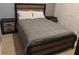 Nicely decorated bedroom featuring a comfortable bed with a gray comforter and bedside tables at 247 Verona Ave, Davenport, FL 33897