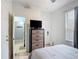Bright bedroom featuring a sleek dresser with a TV and an en-suite bathroom at 247 Verona Ave, Davenport, FL 33897