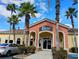 Exterior of Brows Spa Nail & Beauty salon with peach and yellow facade, palm trees, and blue skies at 247 Verona Ave, Davenport, FL 33897