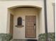 Charming entryway with a secure front door and manicured landscaping, creating a welcoming first impression at 247 Verona Ave, Davenport, FL 33897