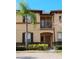 Charming two-story townhome with a small balcony and a well-maintained front yard at 247 Verona Ave, Davenport, FL 33897
