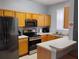 Well-equipped kitchen featuring stainless steel appliances, wooden cabinets, and a breakfast bar at 247 Verona Ave, Davenport, FL 33897