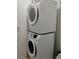 Stacked, energy-efficient, white, front-loading laundry machines are easily accessible in their laundry area at 247 Verona Ave, Davenport, FL 33897