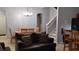 Open-concept living area with a dining table, staircase, and a comfortable sofa at 247 Verona Ave, Davenport, FL 33897