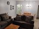 Cozy living room with comfortable sofas and a view into the dining area at 247 Verona Ave, Davenport, FL 33897