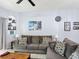 Cozy living room with a brown sofa set, wood table, and picture displays at 247 Verona Ave, Davenport, FL 33897