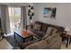 Relaxing living room with a large sofa, stylish decor, and access to outdoor space at 247 Verona Ave, Davenport, FL 33897