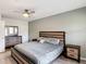 This bedroom features a modern bed frame and matching nightstands with hardwood-style floors and a ceiling fan at 247 Verona Ave, Davenport, FL 33897