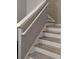 White wood staircase with light wood treads and handrail with neutral paint at 247 Verona Ave, Davenport, FL 33897