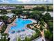 Aerial view showcasing the community pool, mini golf course, lush landscaping, and surrounding area at 256 Captiva Dr, Davenport, FL 33896