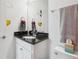 Charming bathroom featuring a granite countertop and a decorative mirror with unique cartoon accents at 256 Captiva Dr, Davenport, FL 33896