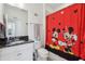 Bathroom with single sink, granite countertop, cartoon-themed shower curtain and tiled flooring at 256 Captiva Dr, Davenport, FL 33896