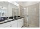 Bathroom with double sink vanity, granite countertop, and tiled shower at 256 Captiva Dr, Davenport, FL 33896