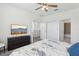 Bedroom with a ceiling fan, TV, en-suite bathroom, and closet for ample storage at 256 Captiva Dr, Davenport, FL 33896