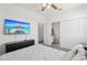 Bright bedroom with a ceiling fan, TV, en-suite bathroom, and closet for ample storage at 256 Captiva Dr, Davenport, FL 33896
