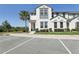 Beautiful townhome showcasing a modern facade, vibrant landscaping, and convenient parking at 256 Captiva Dr, Davenport, FL 33896