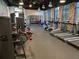 Modern gym featuring treadmills, weights, and exercise machines with brick accent walls and ample lighting at 256 Captiva Dr, Davenport, FL 33896