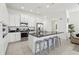 Bright kitchen features white cabinetry, stainless steel appliances, and a large island with barstool seating at 256 Captiva Dr, Davenport, FL 33896