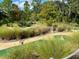 Scenic outdoor mini golf course surrounded by lush greenery, mature trees, and meandering pathways at 256 Captiva Dr, Davenport, FL 33896