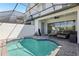 Inviting screened-in pool area with clear blue water, seating, and tranquil setting at 256 Captiva Dr, Davenport, FL 33896