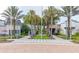 Landscaped town center featuring palm trees, decorative benches, and charming storefronts at 256 Captiva Dr, Davenport, FL 33896