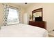 Bedroom with large window and dresser with mirror at 2778 Almaton Loop # 403, Kissimmee, FL 34747