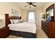 Bedroom featuring a decorative headboard, dresser and neutral decor at 2778 Almaton Loop # 403, Kissimmee, FL 34747